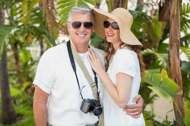 Holidaying couple smiling at camera