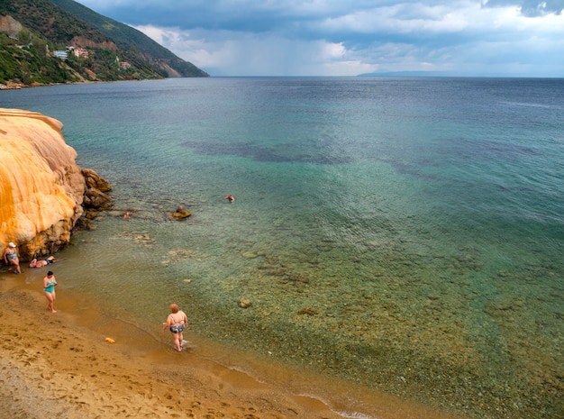 Holidaymakers take natural healing baths at hot springs at spa resort Loutra Edipsou, Evia, Greece