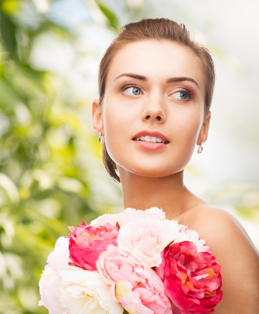 holidays, beauty and jewelry - woman with diamond earrings and flowers