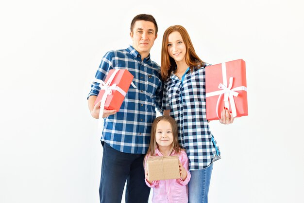 Holidays and celebration concept - Happy family with Christmas presents on white background.