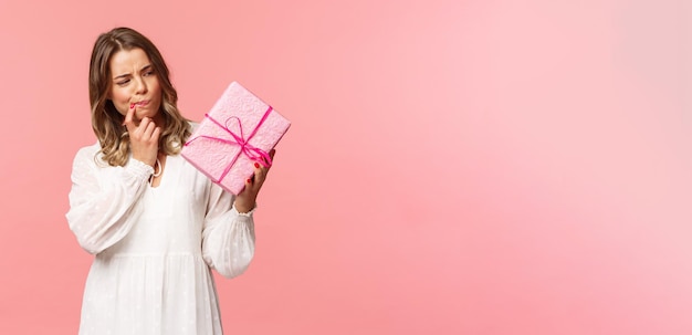 Holidays celebration and women concept portrait of thoughtful curious blond girl thinking whats insi