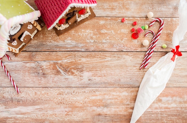 holidays, christmas, baking and sweets concept - closeup of beautiful gingerbread houses at home