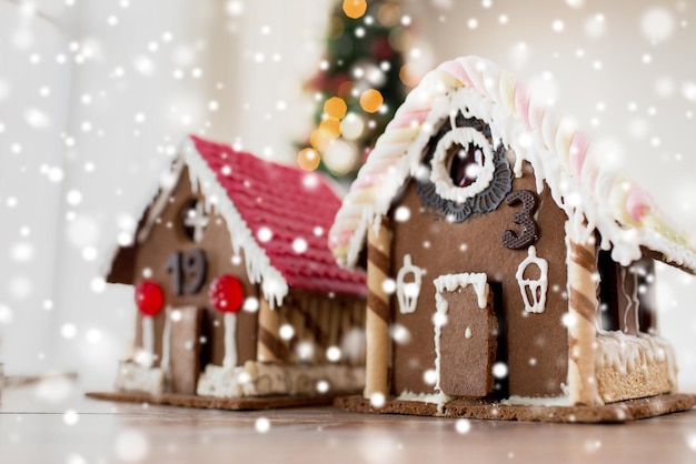 holidays, christmas, baking and sweets concept - closeup of beautiful gingerbread houses at home