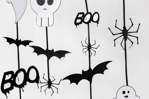 holidays and decoration concept - halloween paper party garlands over white background