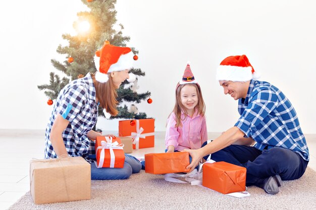 Holidays and festive concept - Happy family portrait by Christmas tree.