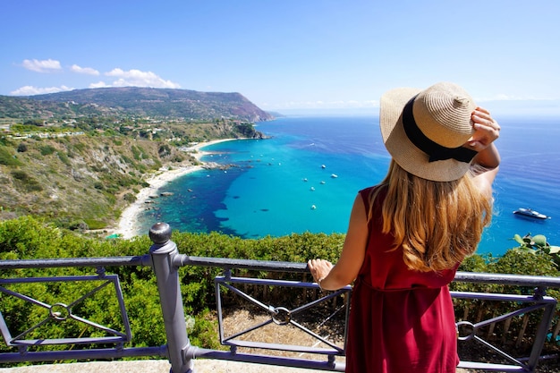 Holidays in Italy Rear view of traveler woman in Capo Vaticano on Coast of the Gods Calabria Italy