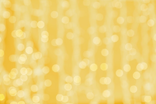 holidays, party and celebration concept - blurred golden background with bokeh lights