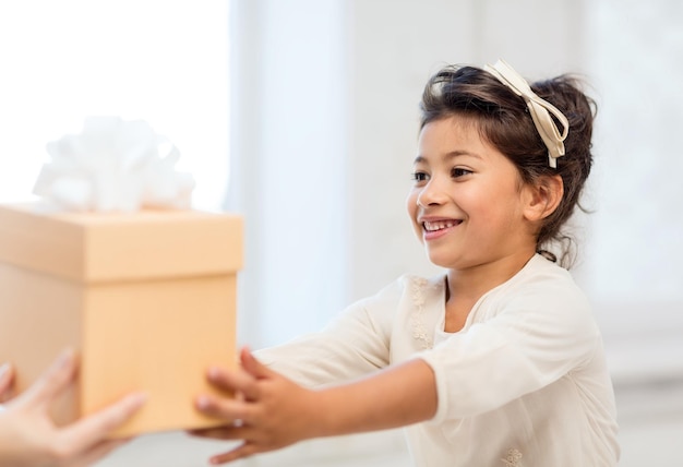 holidays, presents, christmas, x-mas, birthday concept - happy child girl with gift box