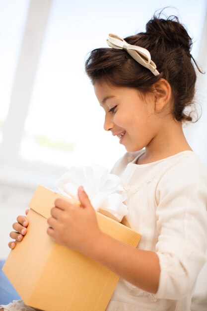 holidays, presents, christmas, x-mas, birthday concept - happy child girl with gift box