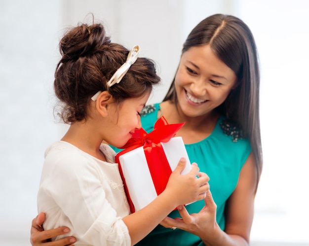 休日、プレゼント、クリスマス、クリスマス、誕生日のコンセプト-ギフトボックス付きの幸せな母と子の女の子