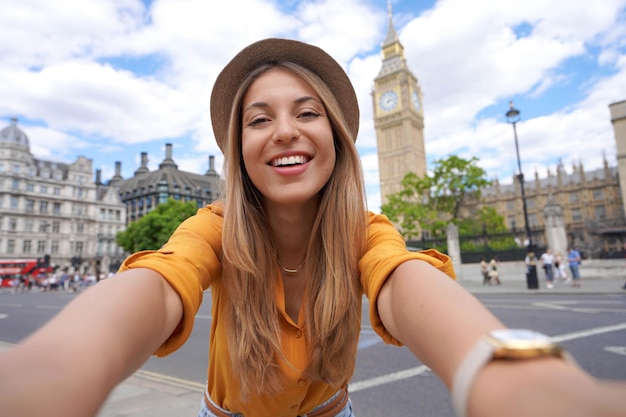 Holidays in UK Brazilian girl takes selfie picture with smartphone in London UK