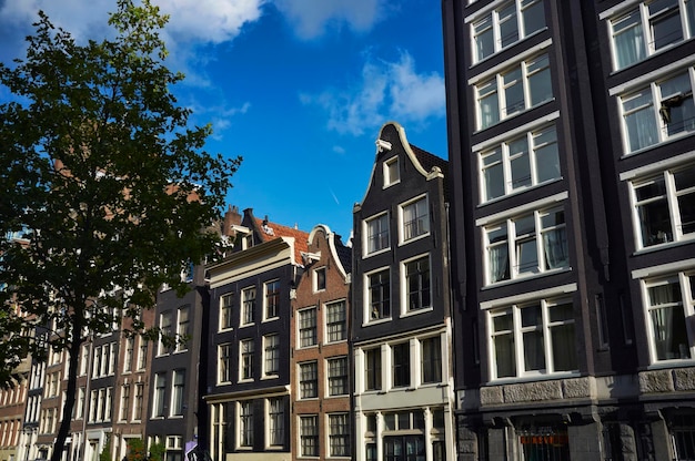 Holland, Amsterdam, the facade of old stone private houses in the center