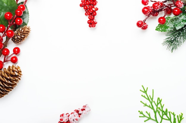 Holly ilex twigs and pinecones top view background.