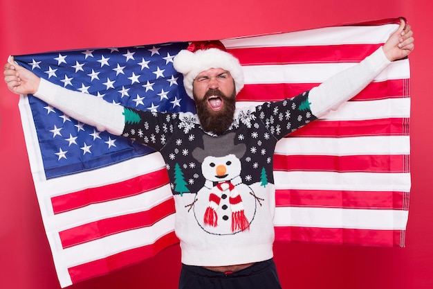 Holly jolly. Patriotic man celebrate xmas and new year. Happy santa hold american flag. Festive patriotic decoration. Patriotic holidays in USA. Christmas greetings from USA. Patriotic spirit.