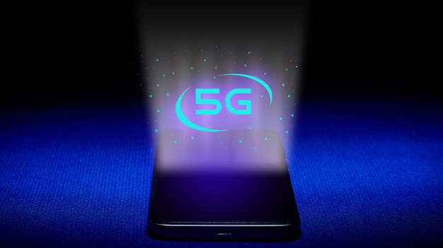 Hologram of 5G.  smartphone and 5G hologram image on blue background. The concept of 5G technology a new generation of networks. - Image