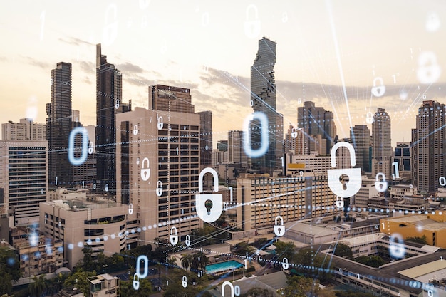 Ologramma del lucchetto sul paesaggio urbano panoramico al tramonto di bangkok nel sud-est asiatico il concetto di cyber security intelligence multi esposizione