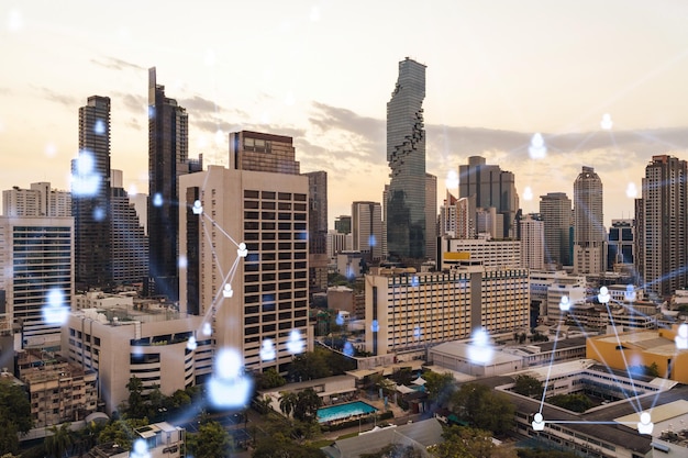 Hologram of social media icons over sunset panoramic cityscape\
of bangkok southeast asia the concept of people connections and\
career opportunities multi exposure