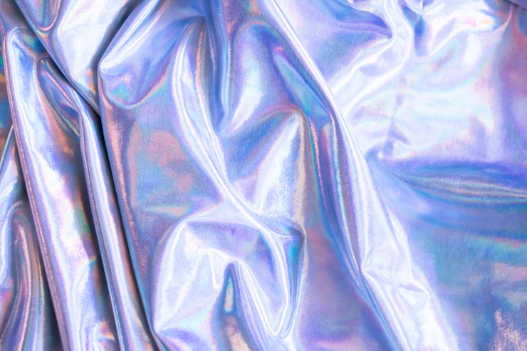 Photo holographic iridescent mermaid foil texture background. futuristic neon trendy silver colors