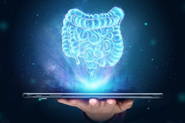 Photo a holographic projection of an intestinal scan over a smartphone.