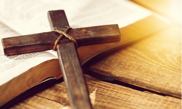 Holy Bible book and cross, close-up view