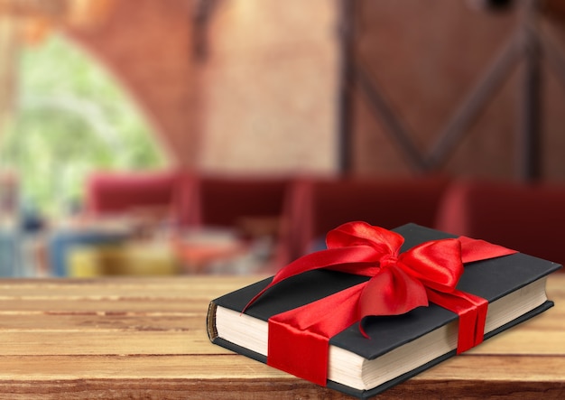 Holy Bible  book in red ribbon on a wooden background