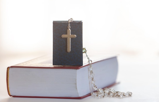 Holy Bible and Rosary with cross