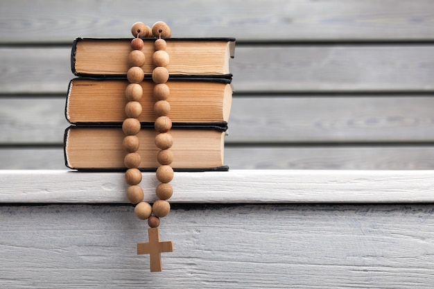 Photo holy book and beads on table, close up