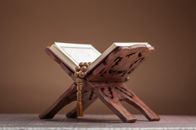 Holy Book of Muslims with breads on dark background