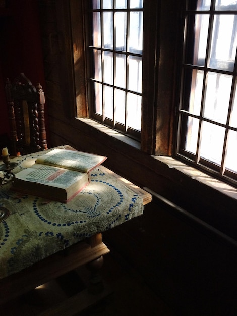 Photo holy book on table by window