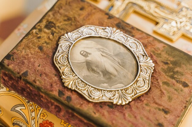 Holy book with picture of Jesus Christ on the table in church