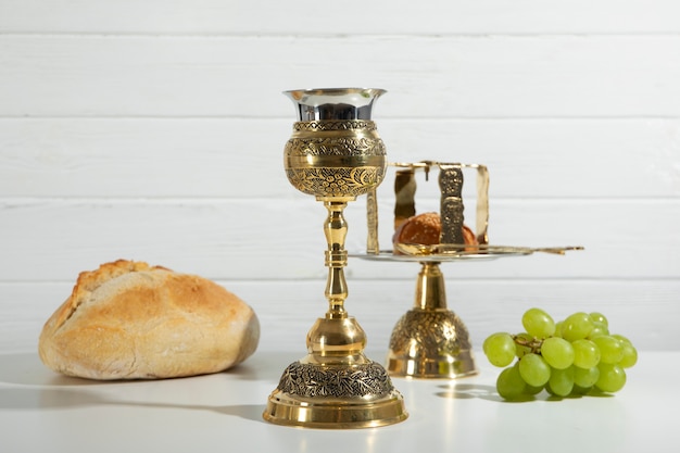 Holy communion with chalice and grapes arrangement