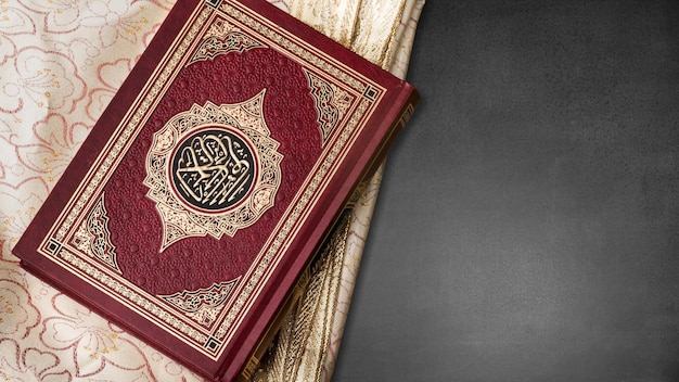 Holy Quran book with written arabic on desk