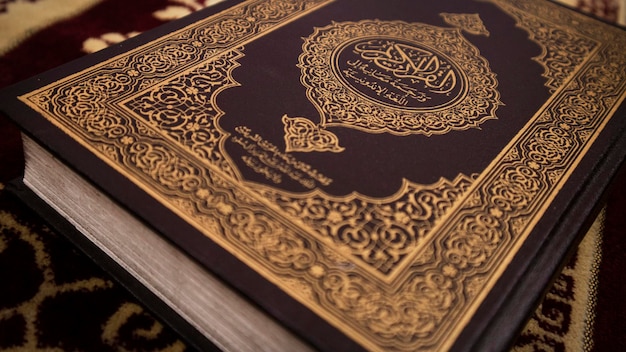 Holy Quran on Top of A Prayer Rug Close Up