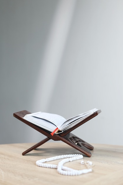 Holy Quran on Wooden Table with Light Beam for Ramadan and Eid Background