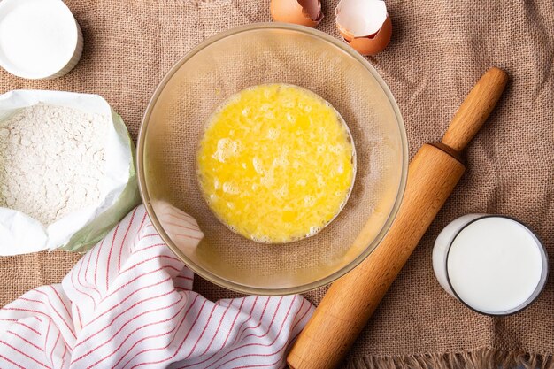 Home Baking whisking eggs for homemade cake Rustic recipe with eggs wholegrain flour sugar and kefir