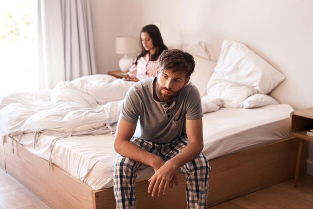 Home bed man and couple with problem marriage conflict or stress over mistake life fail or insomnia Mental health risk mistake and person depressed sad and thinking about divorce in bedroom