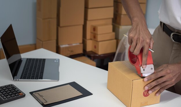 ホームビジネスオンライン配送と梱包小包ボックスのコンセプト中小企業の所有者のパッキングボックス