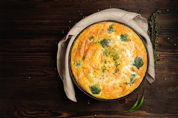 Home cooked frittata on a wooden table. Top view.