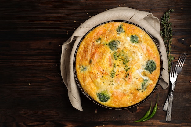 Home cooked frittata on a wooden table. Top view.