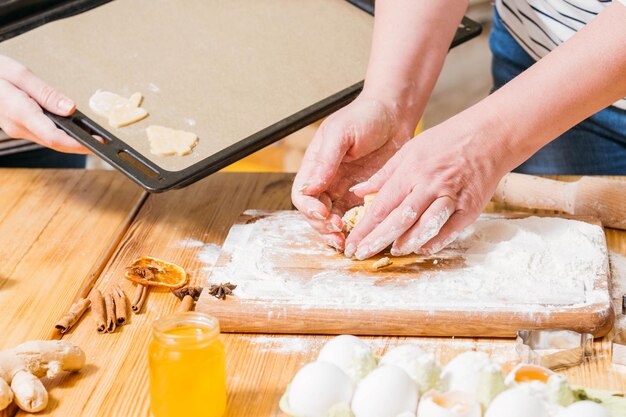 Home culinary hobby Closeup of female hands preparing dough for gingerbread biscuits