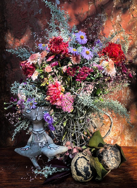 Home decor and flowers arranging Romantic bouquet with dahlias chrysanthemums asters geykhera and wormwood in sunlight on old rusty background