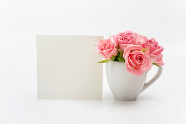 Home decoration, empty card and cup with roses