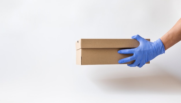 home delivery in a paper box with gloves