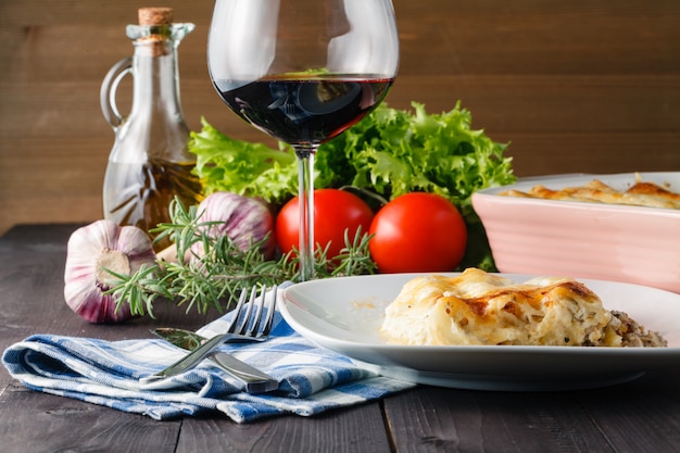 Home dinner with lasagne and wine