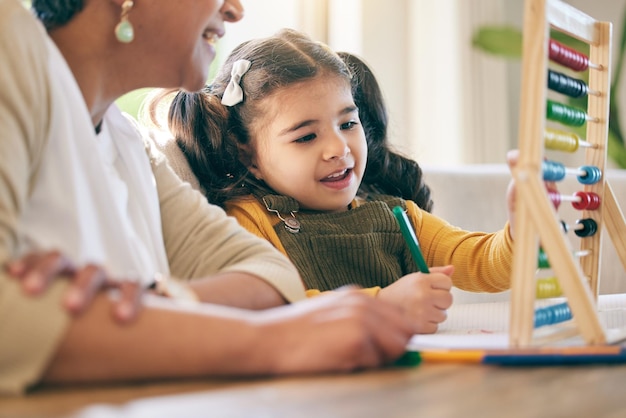 Photo home education and girl child with grandmother abacus and smile for counting project and kindergarten lesson learning math and kid with grandma in living room with love support and study help