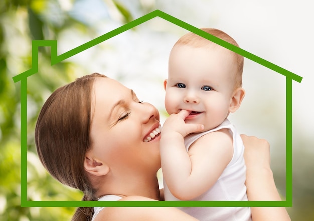 home, family and environment - happy mother with adorable baby and eco house