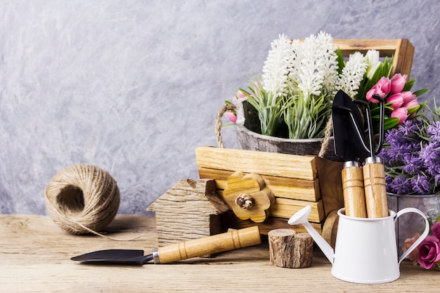 Home and garden concept of gardening tools and flowers on the old wood