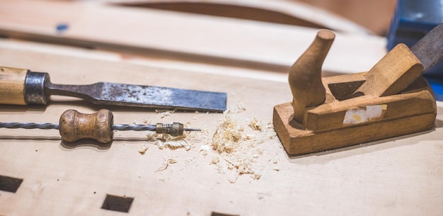 Home handyman using a plane for smoothing down a piece of\
timber