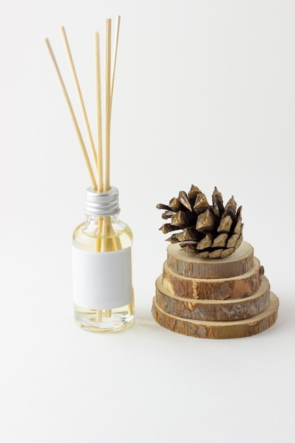 Home incense sticks with natural pine scent. Cones and spruce frame with aroma diffuser. Eco-friendly home fragrance concept