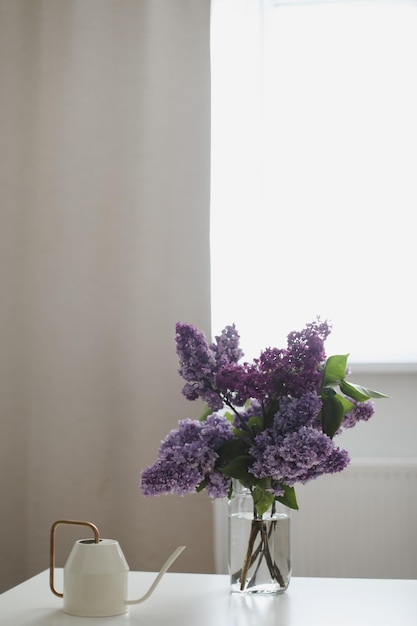 Home interior decor bouquet of lilacs in a vase on table spring still life interior details